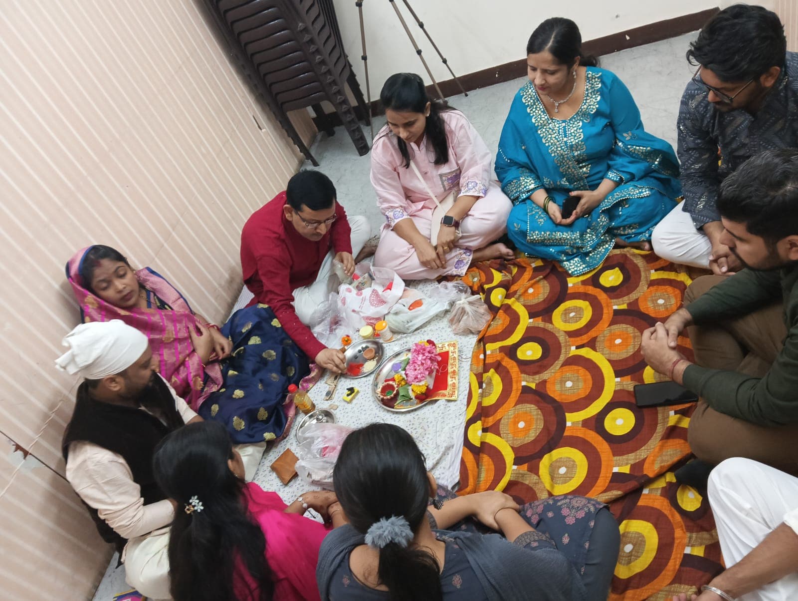 Group gathered around the puja thali
