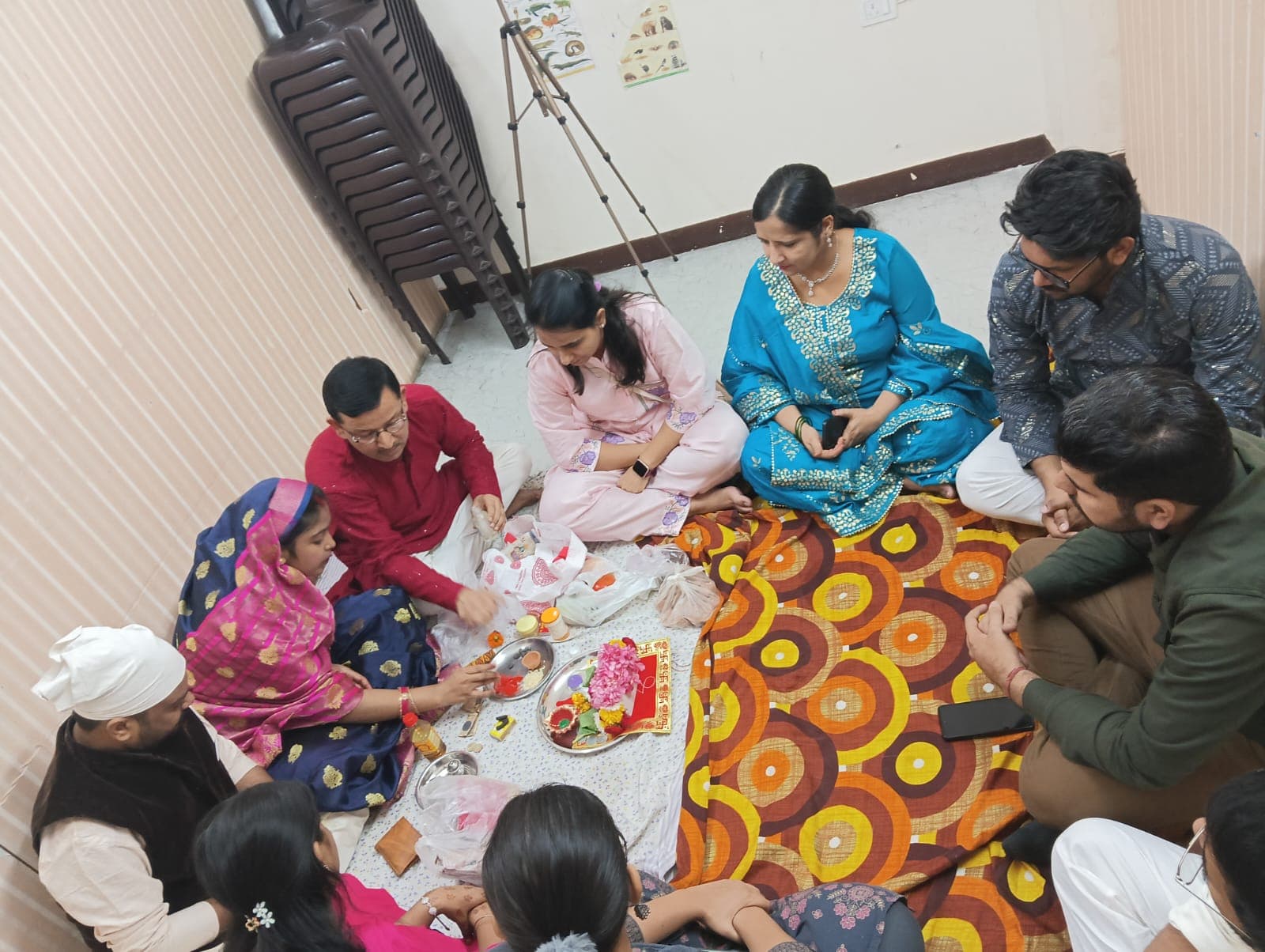 Faculty seated around the puja aarti thali