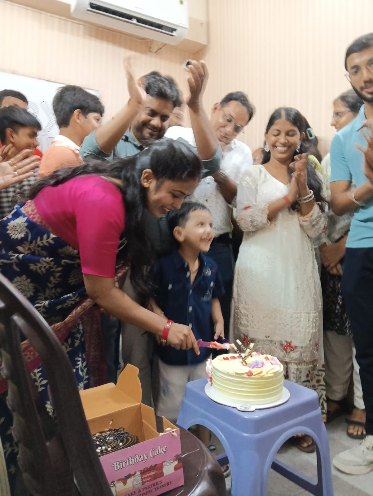 Child cutting birthday cake at ESA