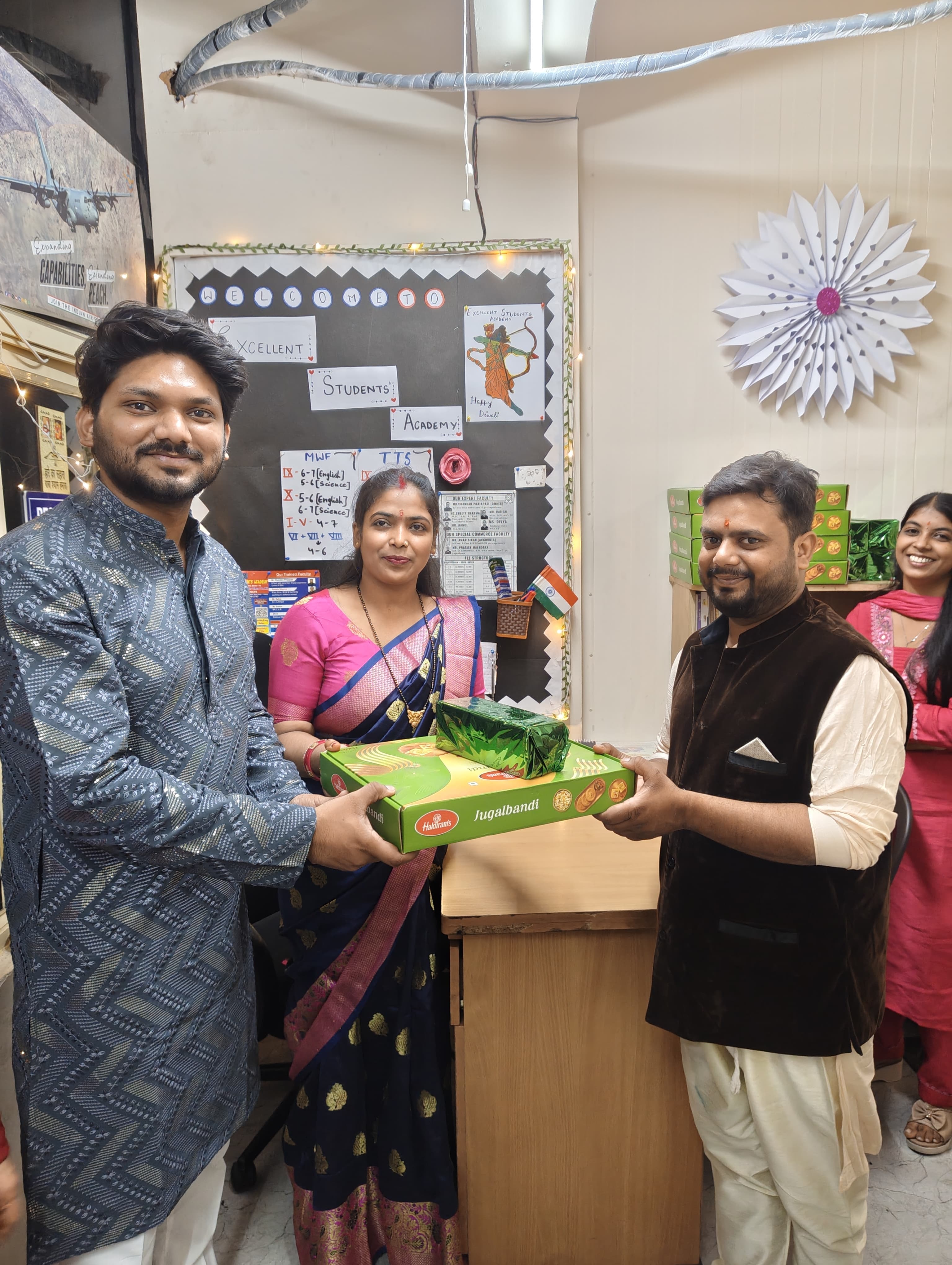 Founder and faculty with sweet box