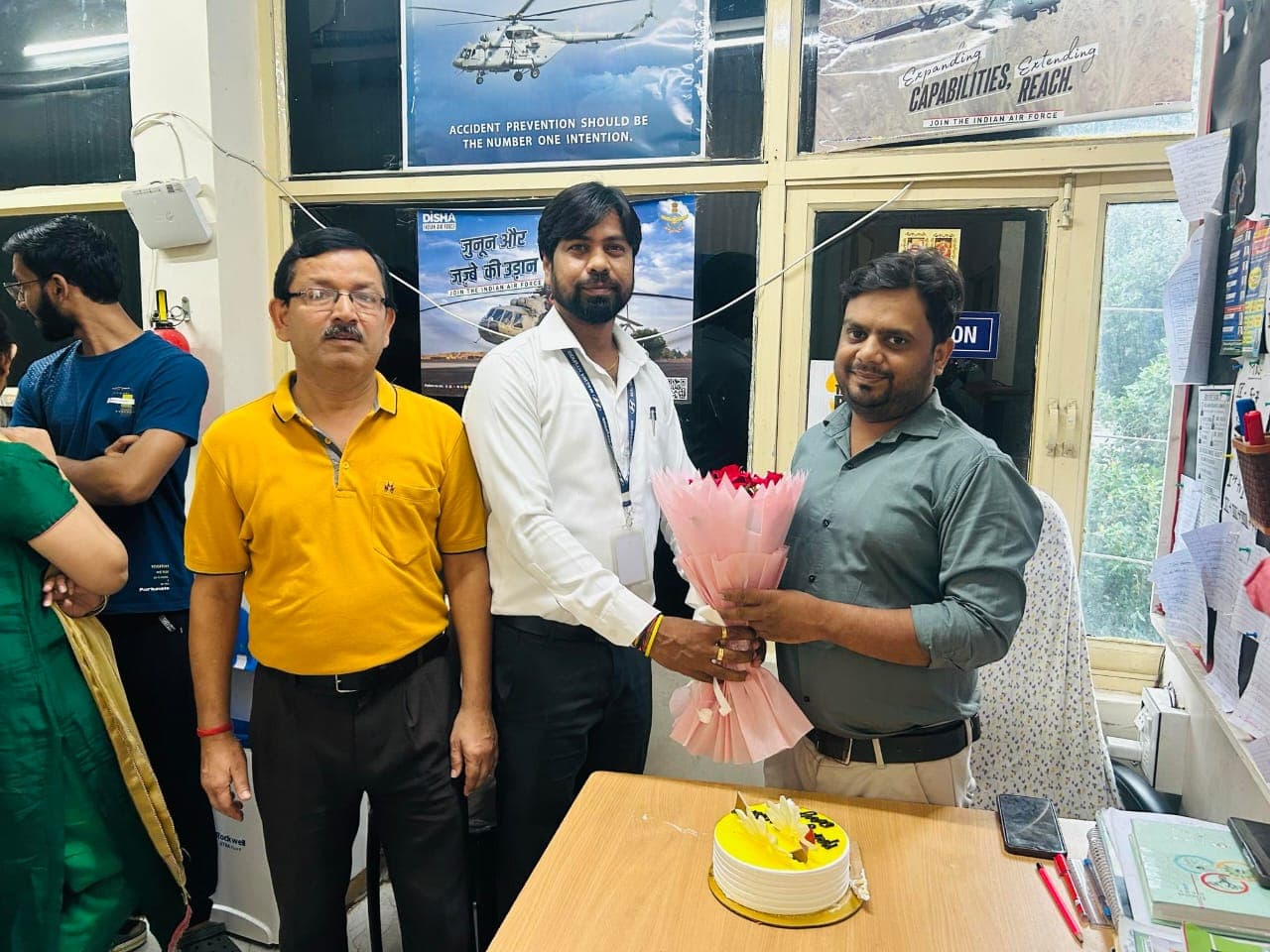 Faculty giving festival sweets to a student