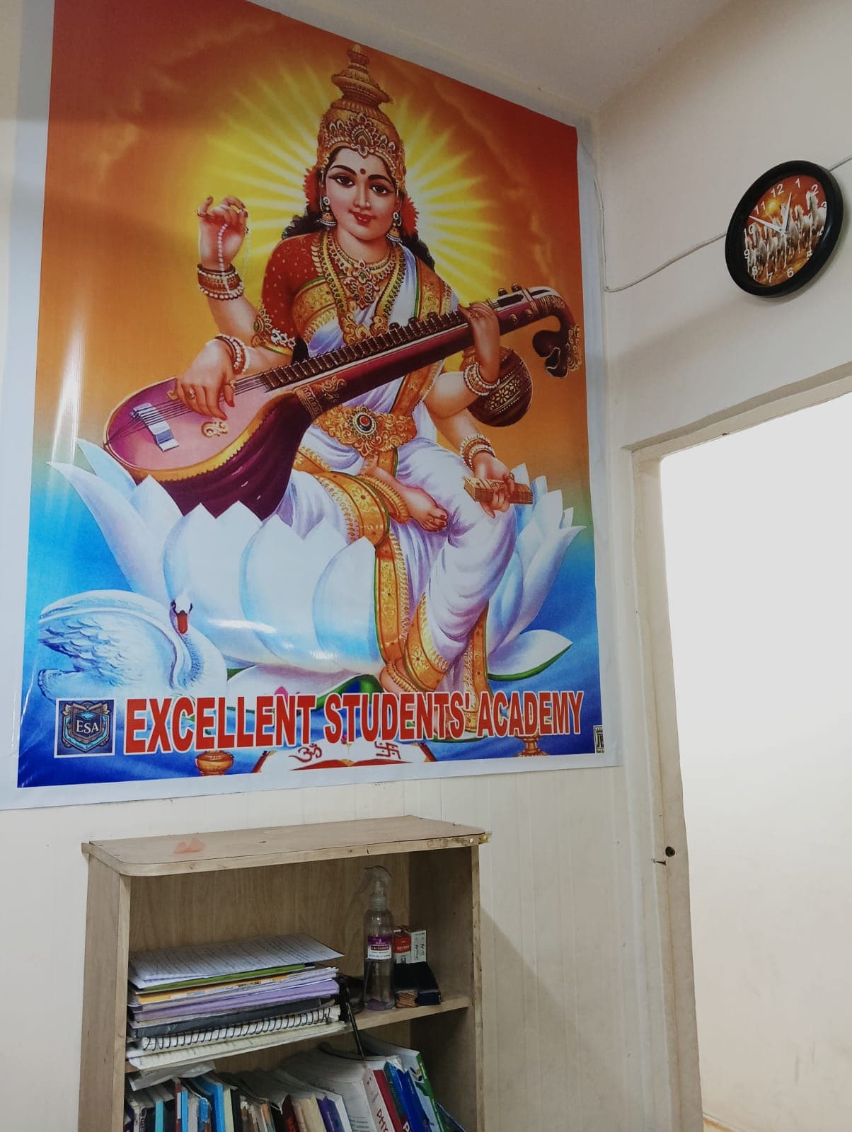 Maa Saraswati poster with Excellent Students Academy banner at the centre
