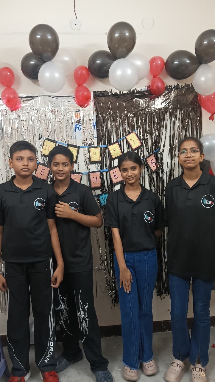 ESA juniors posing in front of Happy Teachers' Day 2026 banner
